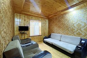 a living room with a couch and two chairs and a television at Gabala Grean Villa in Gabala
