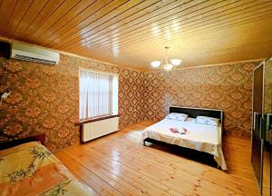 a bedroom with a bed and a wooden ceiling at Gabala Grean Villa in Gabala +15 photos