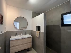 a bathroom with a sink and a mirror at Casa Monte y Mar in Morro del Jable +47 photos