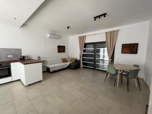 a kitchen and living room with a table and a couch at Casa Monte y Mar in Morro del Jable