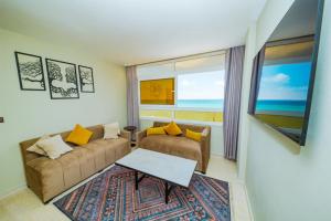 a living room with a couch and a table at Singular Hotel, SH Dakhla in Dakhla