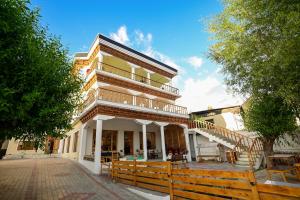 a building with a wooden fence in front of it at Hotel Karakoram in Leh