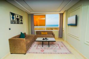 a living room with a couch and a table at Singular Hotel, SH Dakhla in Dakhla