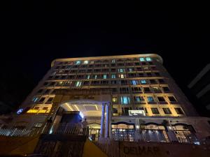 a tall building with lights on it at night at PERLA SUİTES hotel in Istanbul