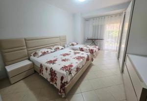 a bedroom with two beds and a window at Casa Kaçi in Mullini i Danit