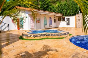 a house with two swimming pools in a yard at Hotel Campestre Santa Catalina in San Gil