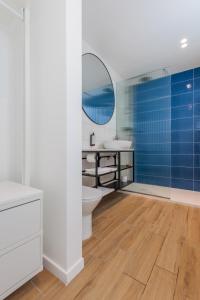 a bathroom with a toilet and a sink and a mirror at Casa Lola in Mellieħa