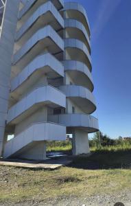 a building with a spiral facade on the side of it at მყუდრო აპარტამენტი ანაკლიაში, Cozy Apartment in Anaklia in Zugdidi