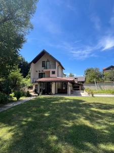 a house with a large lawn in front of it at Nature Villa Sarajevo in Rakovica