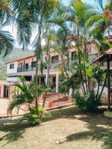 a building with palm trees in front of it at Finca Hotel Villa Alba in San Jerónimo