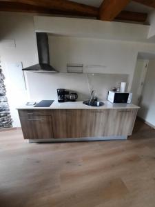 a kitchen with a sink and a microwave at Vista Real in Mugardos +3 photos