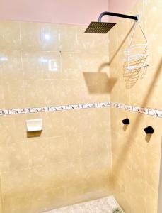 a bathroom with a shower with a shower head at Accommodation near downtown in San Cristóbal de Las Casas +2 photos