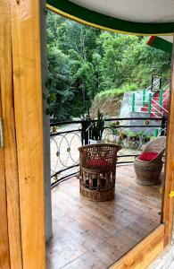 a balcony with a potted plant sitting on a deck at Kepchaki Stay in Takdāh