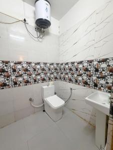 a bathroom with a toilet and a sink at Kepchaki Stay in Takdāh