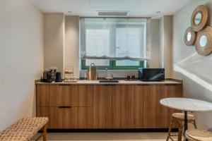 a kitchen with a sink and a window at Suites by Miramar - Adults only in Lloret de Mar