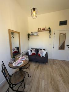 a living room with a couch and a table at Tivat Cozy Studio in Tivat