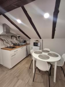 a kitchen and dining room with a table and chairs at Villa Ivana in Koper +6 photos