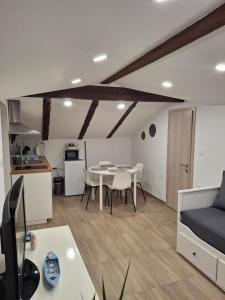 a kitchen and a living room with a table and chairs at Villa Ivana in Koper
