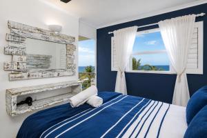 a bedroom with a bed with a fireplace and a window at Chakas Cove in Ballito +98 photos