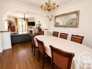 a dining room with a large white table and chairs at Livry Gargan in Livry-Gargan