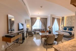 a living room with a couch and a table at La Zona Continental Hotel in Dubai