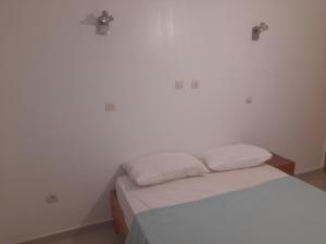 a bedroom with a bed with two pillows on it at Residence du fromager in Bouaké