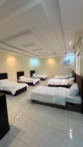 a room with four beds in a room at فيلا هابي نايت in Ash Shafa