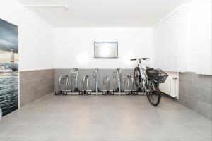 a bike parked in a room with chairs at Hotel Garni Brugger in Lindau
