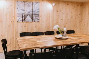 a dining room with a wooden table and chairs at Lavandas apartamenti in Ikšķile
