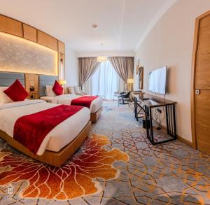 a hotel room with two beds and a desk at La Zona Continental Hotel in Dubai +131 photos