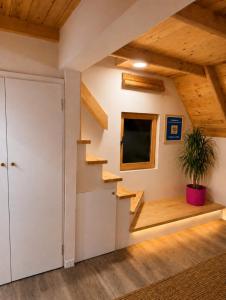 a staircase in a room with a door and a potted plant at Chechar Inn Zlatar in Nova Varoš +129 photos