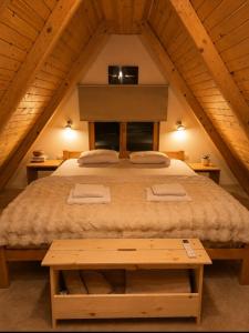 a bedroom with a large bed in a attic at Chechar Inn Zlatar in Nova Varoš