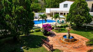 an aerial view of a garden with a fountain and a pool at Hotel Campestre Santa Catalina in San Gil