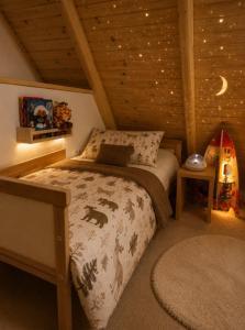 a bedroom with a bed in a attic at Chechar Inn Zlatar in Nova Varoš