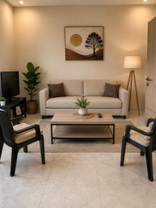 a living room with a couch and a coffee table at Kala's apartment farato in Medina Suware Kunda