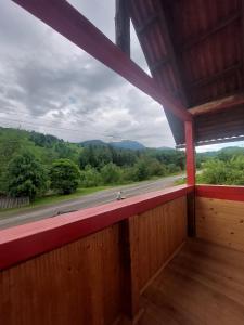 a room with a window with a view of a road at Casa Curcubeu in Ceahlău