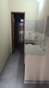 an empty kitchen with a sink and a hallway at Monoambiente en villa Elisa in Villa Elisa