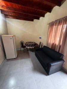 a living room with a couch and a table at Monoambiente en villa Elisa in Villa Elisa