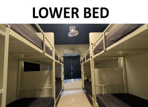 a room with two bunk beds and the words lower bed at Thuyil Inn Koodal in Madurai