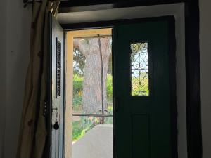 a green door with a window in a room at Casa do Caseiro by Quinta da Burra in Cartaxo +10 photos