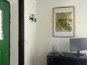 a room with a tv and a cross on a wall at Casa do Caseiro by Quinta da Burra in Cartaxo