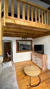 a living room with a couch and a table at Studio in Saint-Martin-Vésubie