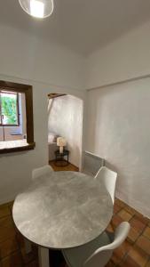 a white table and chairs in a room at Studio in Saint-Martin-Vésubie