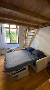 a large bed in a room with a staircase at Studio in Saint-Martin-Vésubie