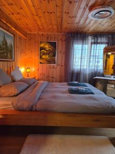 a bedroom with a large bed with a wooden ceiling at Duplex Salgesch in Salgesch