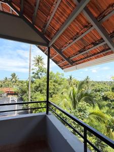 a balcony with a view of the jungle at Lakeside Meadows- Diamond Homestay in Kollam