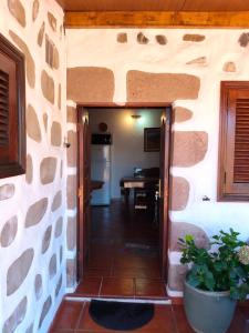 an entrance to a house with a table in a room at Casita Roque Nublo in Tejeda