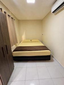 a bedroom with a bed in a small room at Hotel ideal 2 in Inocência