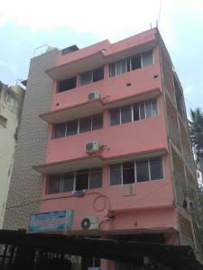 a pink building with a sign in front of it at Terrace Camp inn in Tiruchirappalli