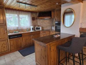a kitchen with wooden cabinets and a counter top at Duplex Salgesch in Salgesch